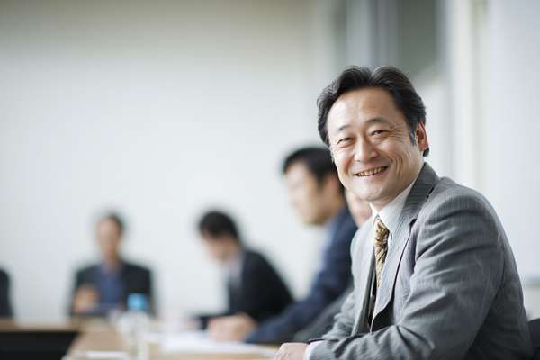 会議室で笑顔を見せるビジネスマン