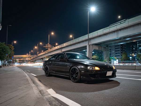 都会の夜道を走る漆黒のスポーツカー