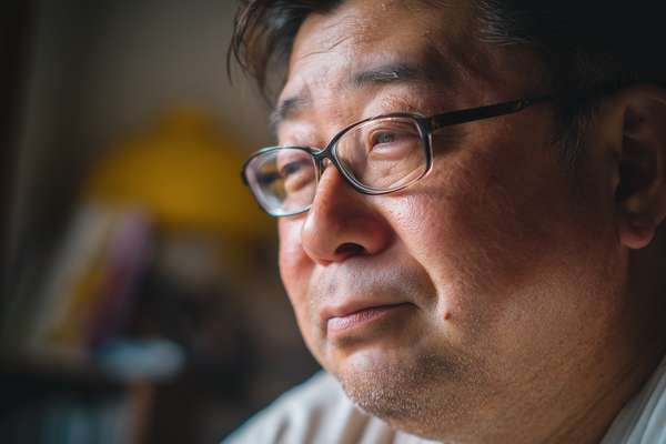 眼鏡をかけた中年男性の横顔